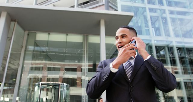 Businessman Talking On Mobile Phone In Front Of Modern Office Building - Download Free Stock Images Pikwizard.com