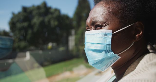 Woman Wearing Face Mask Looking Out Window During Pandemic - Download Free Stock Images Pikwizard.com