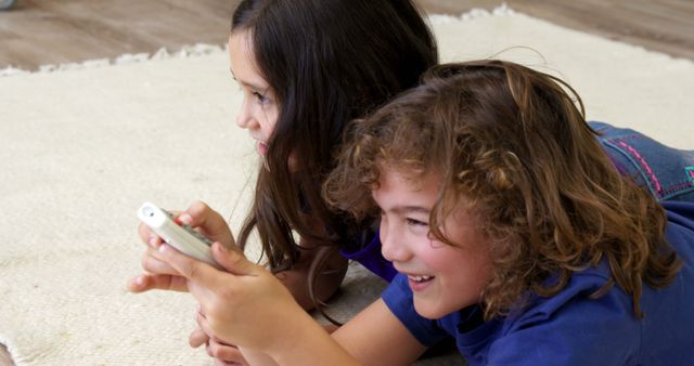 Children Using Remote Control While Lying on Carpet - Download Free Stock Images Pikwizard.com