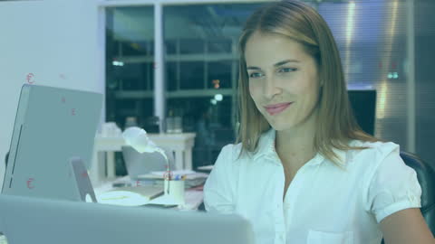 Businesswoman Analyzing Data on Laptop in Office Environment