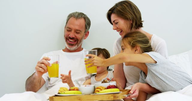 Happy Family Having Breakfast in Cozy Bedroom - Download Free Stock Images Pikwizard.com