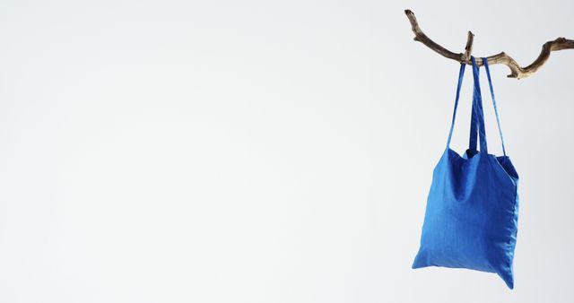 Blue Cotton Tote Hanging on Wood Branch Against White Background - Download Free Stock Images Pikwizard.com