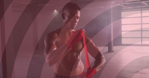 Determined Boxer Wrapping Hands in Intense Gym Setting