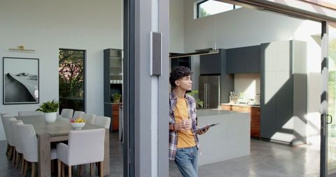 Young Man Contemplating in Modern Minimalist Kitchen Space