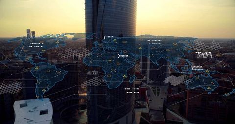 Holographic world map projecting over city skyline at sunset with network data visualization