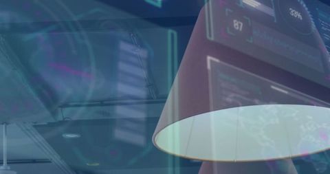 Modern lamp illuminating digital interface in tech office