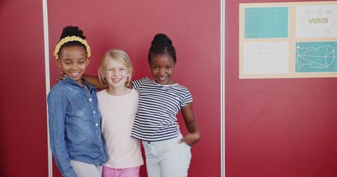 Diverse Girls Posing Happily in School Corridor