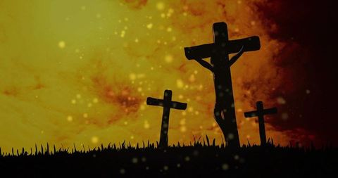 Dramatic three-cross silhouette on hill at sunset with floating embers and fiery sky