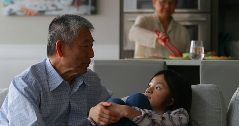 Granddaughter Spending Quality Time with Her Grandfather at Home