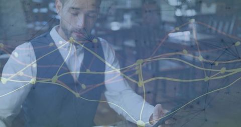 Businessman tapping smartphone in cafe with data network overlay for digital analytics