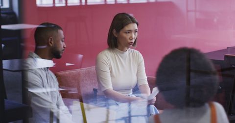 Diverse Professionals Discussing Paperwork in Modern Office - Download Free Stock Images Pikwizard.com