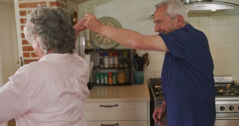 Senior Couple Enjoying Dance in Kitchen
