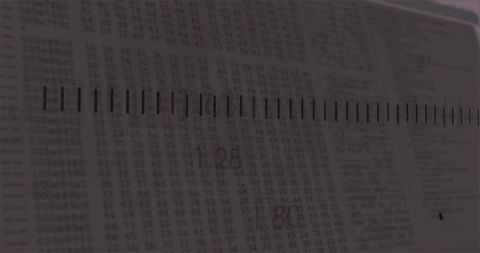 Black ruler crossing printed data table showing 128 and 80 macro measurement