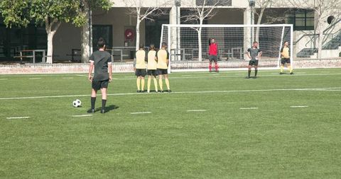 Teen Soccer Player Taking Precision Free Kick on School Field
