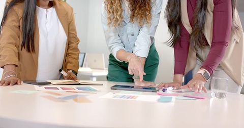 Diverse Team Collaborating over Design Elements in Modern Office