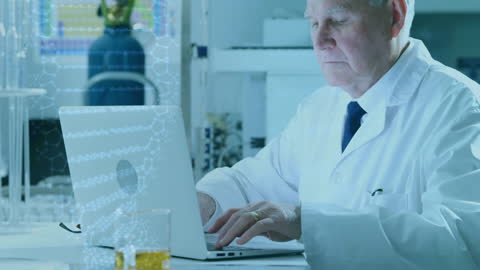 Senior Scientist Analyzing Data on Laptop in Laboratory