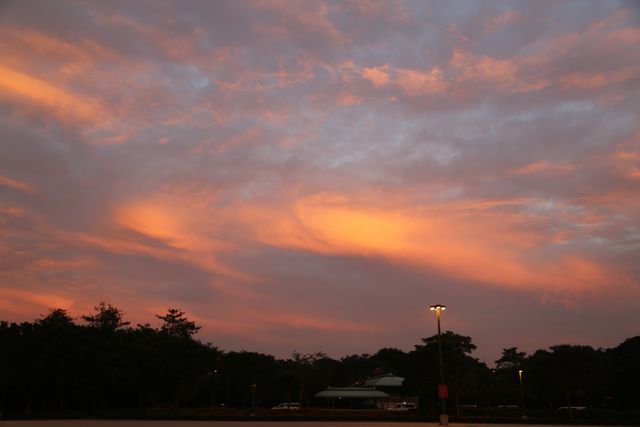 Sunset Sky with Vibrant Cloud Patterns over Parking Lot - Download Free Stock Photos Pikwizard.com