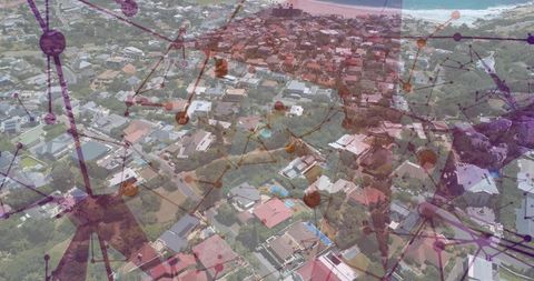 Aerial coastal suburb with smart network overlay connecting homes and rooftops