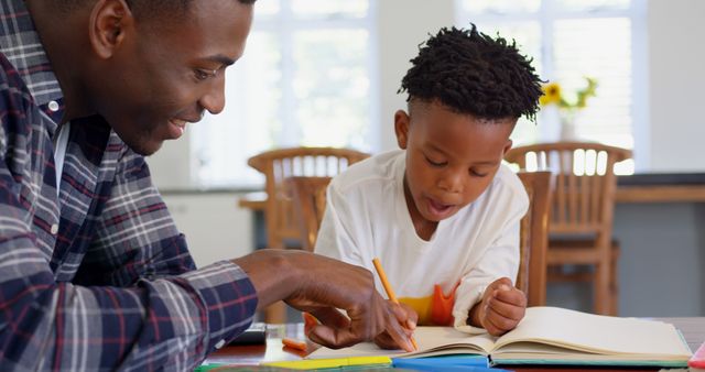 Father Helping Son with Homework at Kitchen Table - Download Free Stock Images Pikwizard.com