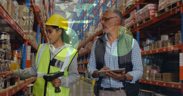 Full view of a male Caucasian warehouse manager writing on a clipboard while accompanying his female Hispanic worker. Digital image of graphs and statistics are running in the foreground