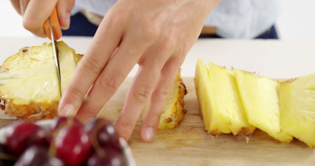 Hands Slicing Fresh Pineapple with Bowl of Cherries - Download Free Stock Images Pikwizard.com