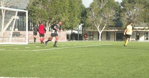 Intense soccer match with athlete kicking goal