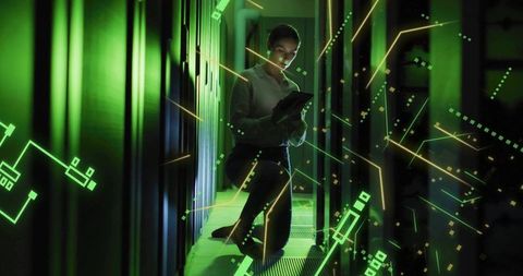 Kneeling IT Technician Monitoring Servers with Neon Green Holographic Network Overlays