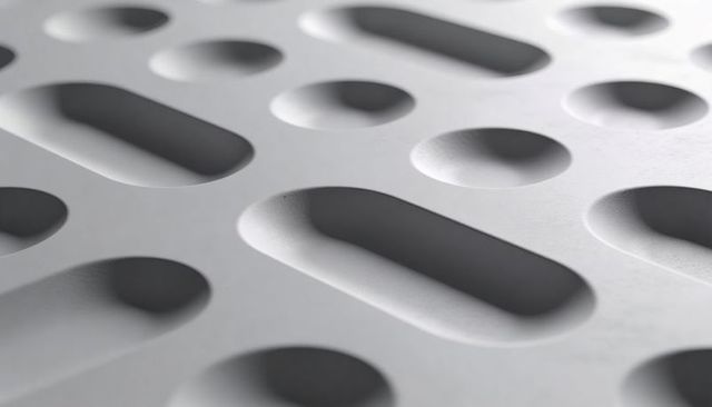 Molded panel featuring recessed oval and circular indents, minimalist textured macro pattern