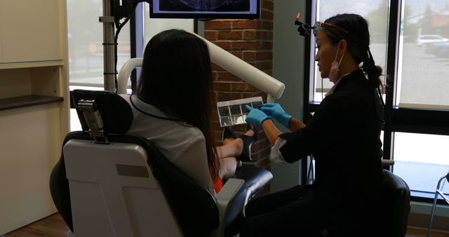 Dentist Treating Female Patient with Advanced Equipment in Dental Clinic - Download Free Stock Images Pikwizard.com