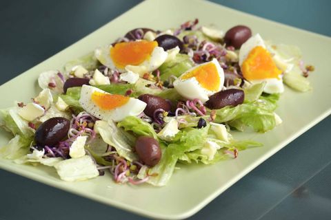 Mediterranean lettuce salad with soft-boiled eggs, kalamata olives, sprouts and crumbled feta