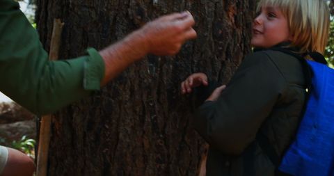 Child Enjoying Playful Outdoor Adventure Among Trees