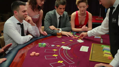 Friends Enjoying a Thrilling Poker Game at Casino Table