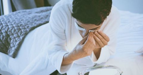 Serene Man Applying Under Eye Mask for Relaxation
