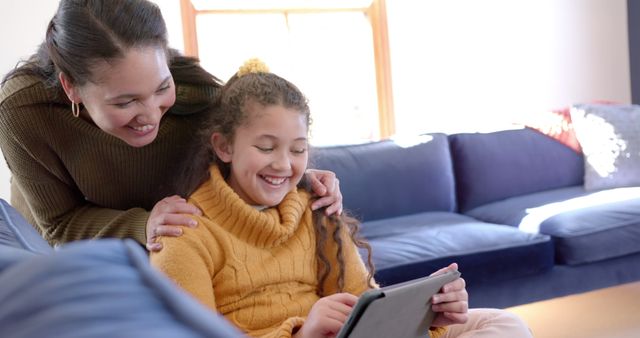 Smiling Mother and Daughter Using Tablet Together on Couch - Download Free Stock Images Pikwizard.com