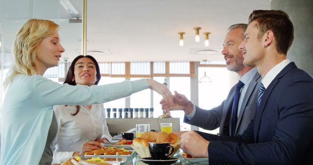 Business Colleagues Shaking Hands During Casual Meeting Over Breakfast - Download Free Stock Images Pikwizard.com