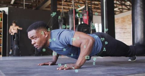 Man Performing Push-Ups with Health Icons in Modern Gym