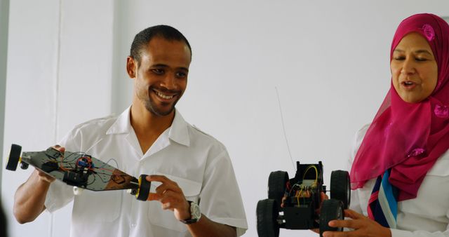 Two Engineers Presenting Robot Cars During Workshop - Download Free Stock Images Pikwizard.com