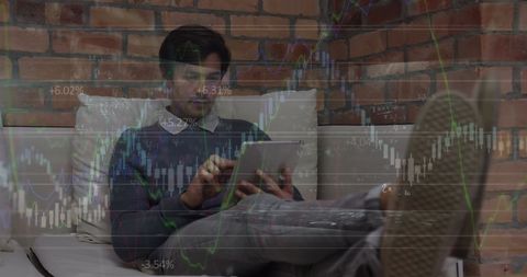 Man Analyzing Financial Data on Tablet with Overlaid Stock Chart