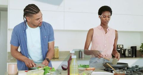 Young Couple Cooking Together in Bright Modern Kitchen Preparing Healthy Weeknight Meal