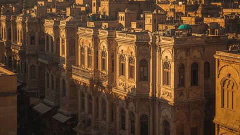 Ornate sandstone facades in golden sunset light