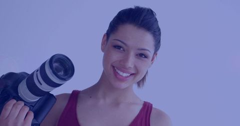 Smiling Female Photographer Holding Camera