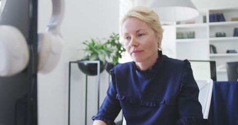 Focused Businesswoman Working Diligently in Modern Office
