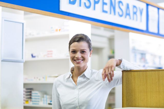 Portrait of smiling pharmacist standing in pharmacy