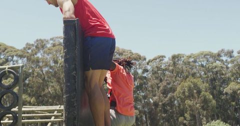 Diverse Fit Men Conquering Outdoor Obstacle Course Together