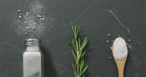 Rosemary and Salt Arrangement on Stone Background