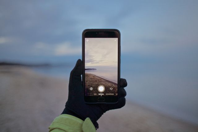 Capturing Coastal Scenery with Smartphone on Winter Beach - Download Free Stock Images Pikwizard.com