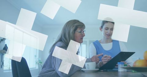 Healthcare Consultation with Doctor and Senior Patient Discussing Records