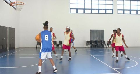 Men's Basketball Game in Indoor Gym with Team Players