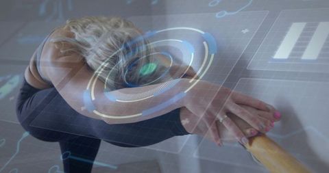 Ballet dancer stretching at barre with augmented reality hud overlay for fitness