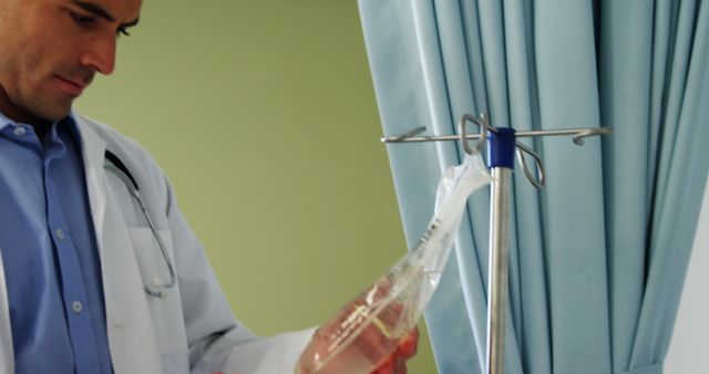 Professional Doctor Examining IV Fluid Bag in Hospital Room - Download Free Stock Images Pikwizard.com